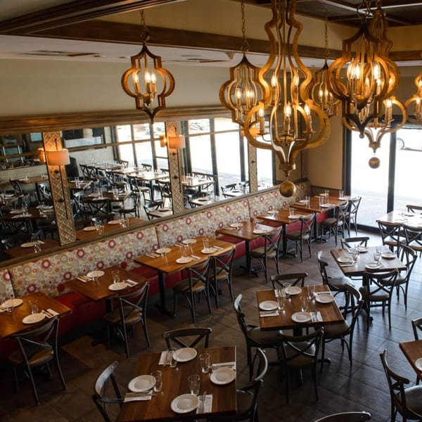 Overhead view of Krinti Mediterranean Grill's dining room with tables, chairs, and ornate chandeliers.