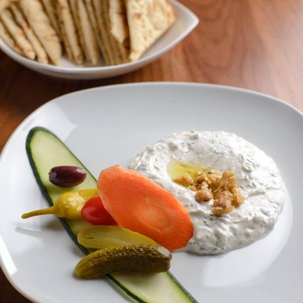 Krinti Mediterranean Grill's creamy dip with walnuts, olive oil, and pickled vegetables, served with pita bread.